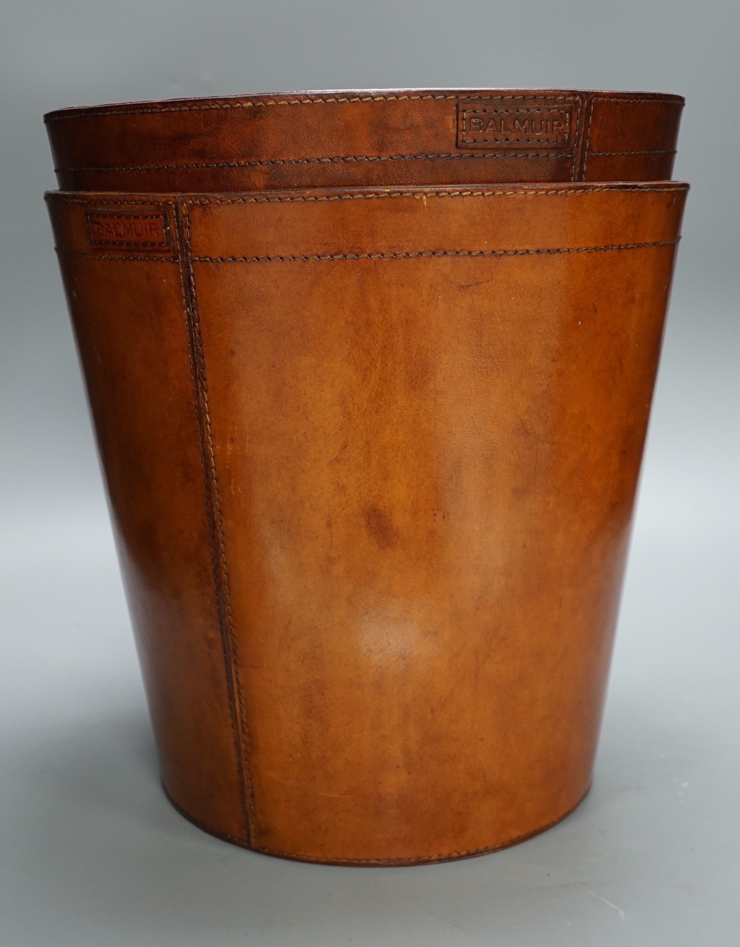 Two leather waste paper bins, 30cms high